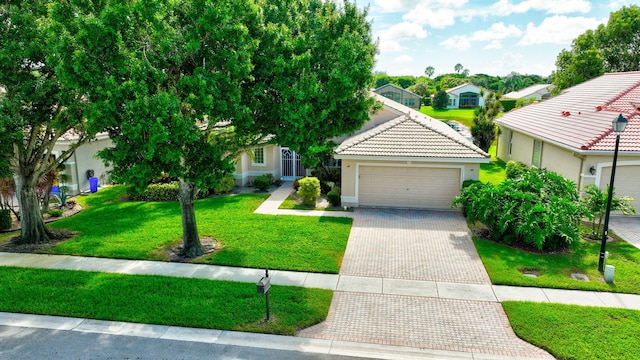 view of front of house with a garage and a front lawn