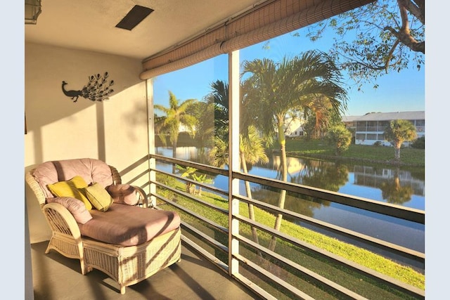 sunroom / solarium with a wealth of natural light and a water view