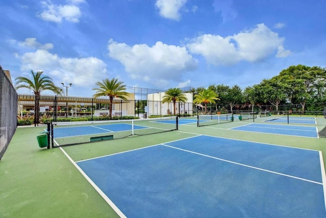 view of tennis court featuring fence