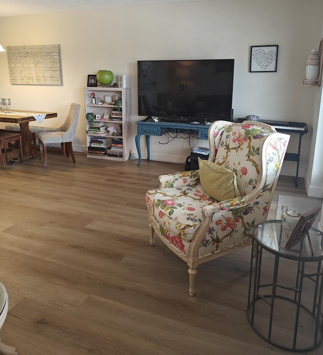 living room with baseboards and wood finished floors