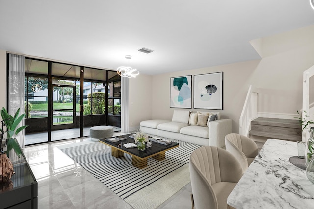 4820 NW 22nd St Unit 4134, Coconut Creek, FL 33063 - living room with baseboards and a chandelier