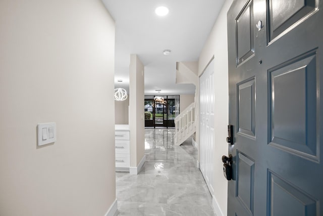 4820 NW 22nd St Unit 4134, Coconut Creek, FL 33063 - hall with baseboards, light marble finish flooring, and stairs