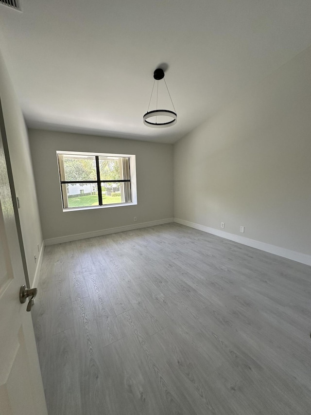 empty room with hardwood / wood-style floors