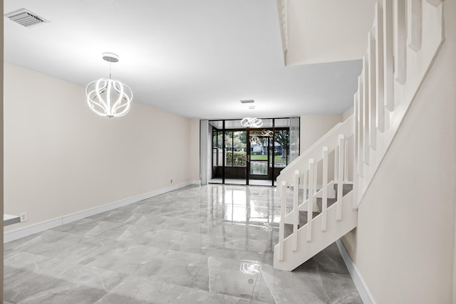 4820 NW 22nd St Unit 4134, Coconut Creek, FL 33063 - foyer with a chandelier, marble tiled flooring, baseboards, and stairway