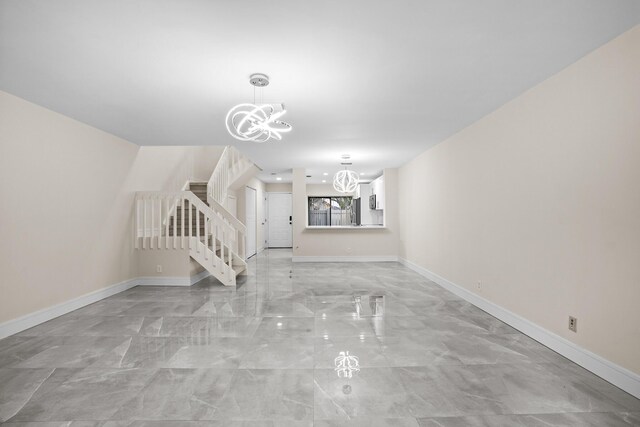 4820 NW 22nd St Unit 4134, Coconut Creek, FL 33063 - unfurnished living room with a chandelier, stairs, light marble finish flooring, and baseboards