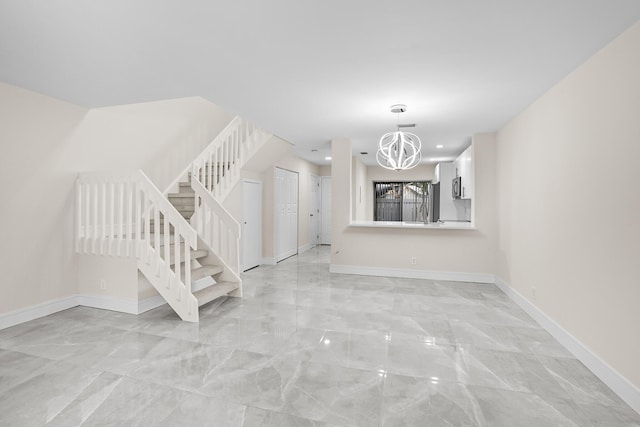 4820 NW 22nd St Unit 4134, Coconut Creek, FL 33063 - unfurnished living room with light marble finish flooring, stairway, a chandelier, baseboards, and recessed lighting