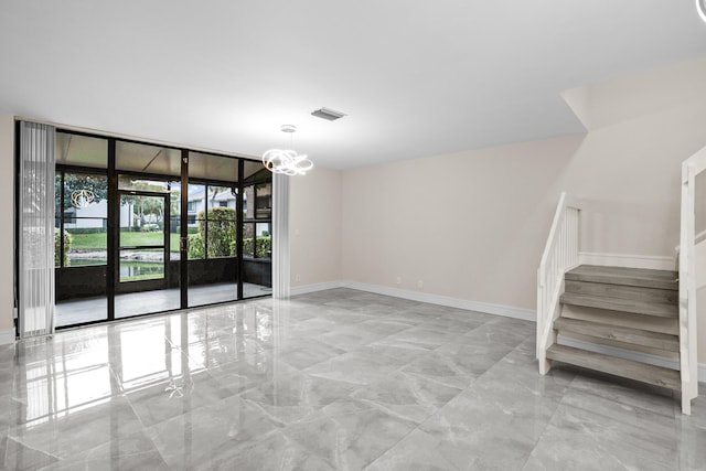 4820 NW 22nd St Unit 4134, Coconut Creek, FL 33063 - empty room featuring marble tiled floors, stairs, a chandelier, baseboards, and expansive windows