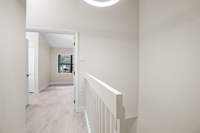4820 NW 22nd St Unit 4134, Coconut Creek, FL 33063 - hallway with an upstairs landing, light wood-style flooring, and baseboards