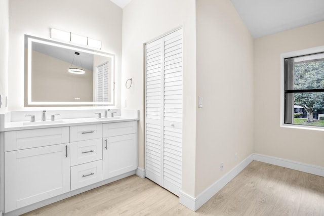 4820 NW 22nd St Unit 4134, Coconut Creek, FL 33063 - bathroom with wood finished floors, double vanity, a closet, and baseboards