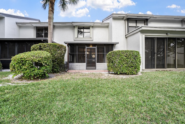 4820 NW 22nd St Unit 4134, Coconut Creek, FL 33063 - back of property with a sunroom, stucco siding, and a yard