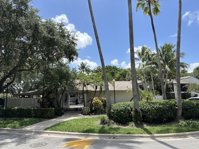 4820 NW 22nd St Unit 4134, Coconut Creek, FL 33063 - view of front of home featuring a fenced front yard, a gate, and stucco siding