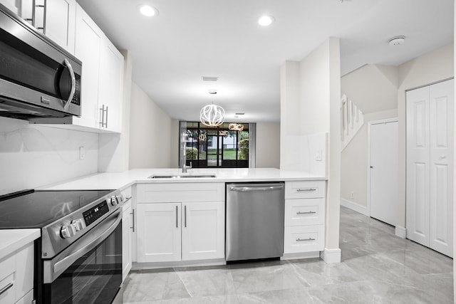4820 NW 22nd St Unit 4134, Coconut Creek, FL 33063 - kitchen featuring appliances with stainless steel finishes, light countertops, recessed lighting, white cabinetry, and a chandelier