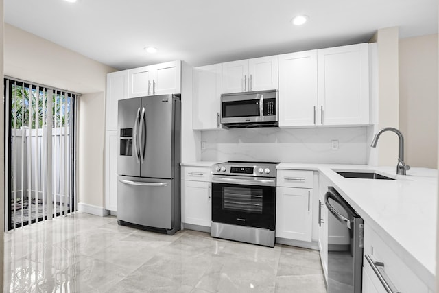 4820 NW 22nd St Unit 4134, Coconut Creek, FL 33063 - kitchen featuring appliances with stainless steel finishes, a sink, recessed lighting, white cabinets, and tasteful backsplash