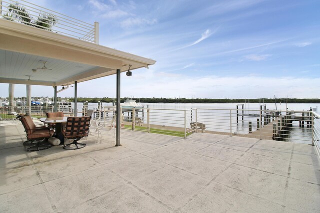 view of patio featuring a boat dock and a water view