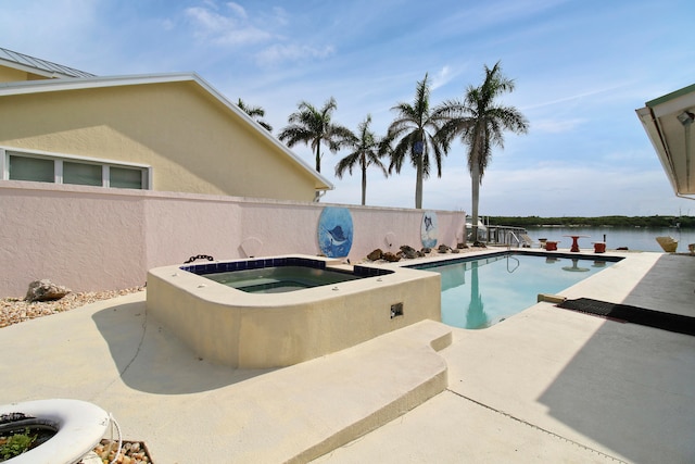 view of pool featuring an in ground hot tub, a patio, and a water view