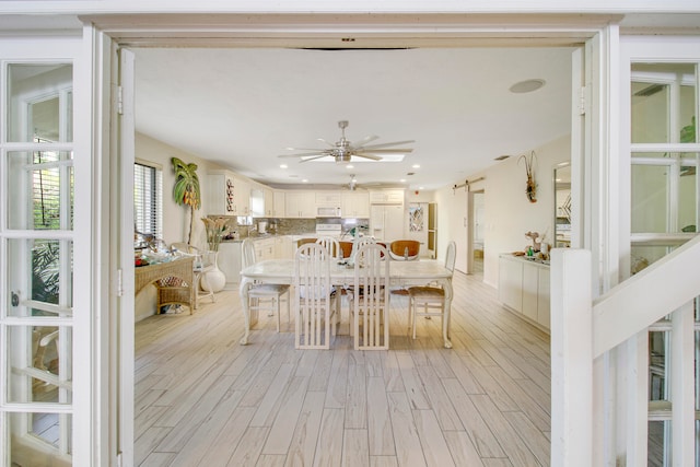 dining room featuring light hardwood / wood-style flooring and ceiling fan