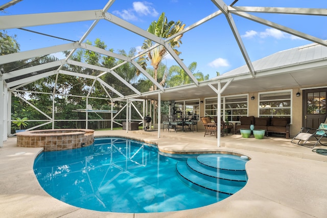 view of swimming pool featuring an in ground hot tub, glass enclosure, and a patio area