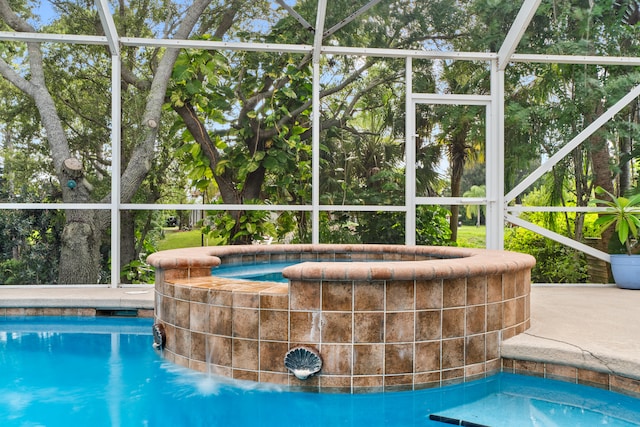 view of swimming pool featuring a lanai