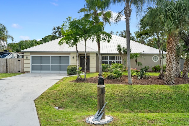 ranch-style home featuring a front lawn and a garage