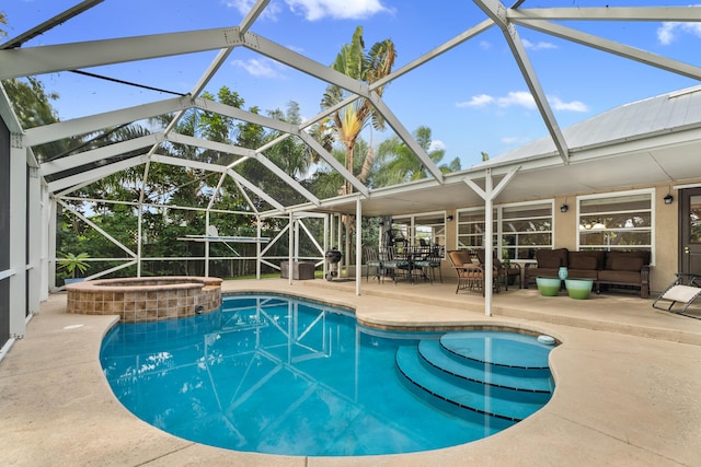 view of pool with an in ground hot tub, a lanai, and a patio area