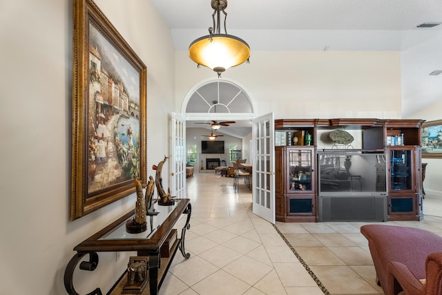 corridor with light tile patterned floors and french doors