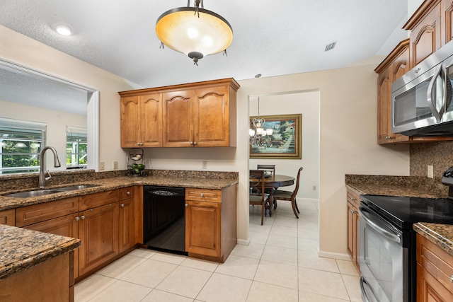 kitchen featuring dishwasher, dark stone countertops, light tile patterned flooring, electric range, and sink