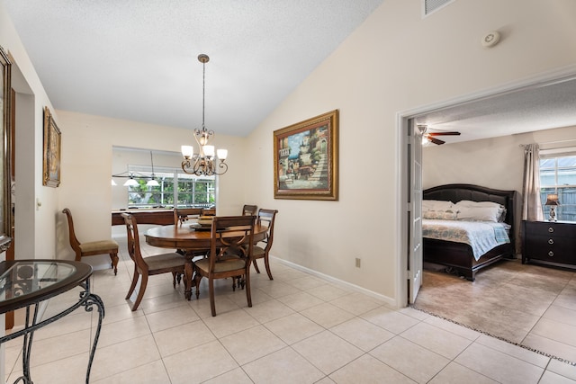 tiled dining area with an inviting chandelier, lofted ceiling, and a textured ceiling