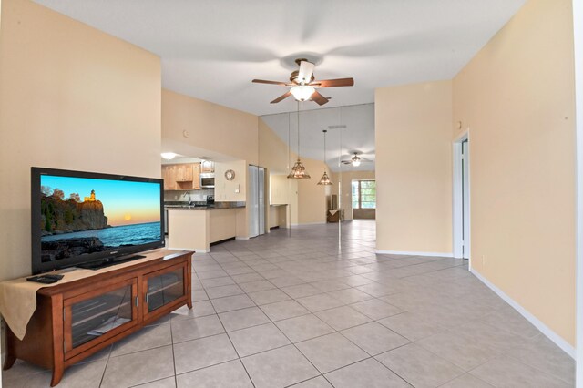 tiled living room with ceiling fan and high vaulted ceiling