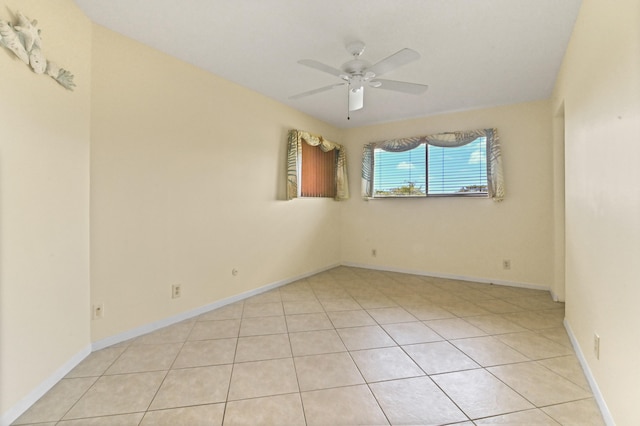 tiled spare room featuring ceiling fan