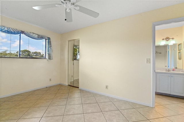 unfurnished room featuring ceiling fan and light tile patterned floors