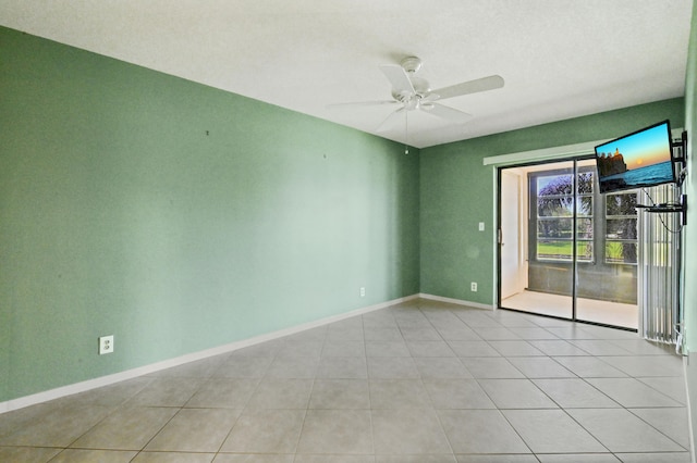 spare room with light tile patterned floors and ceiling fan