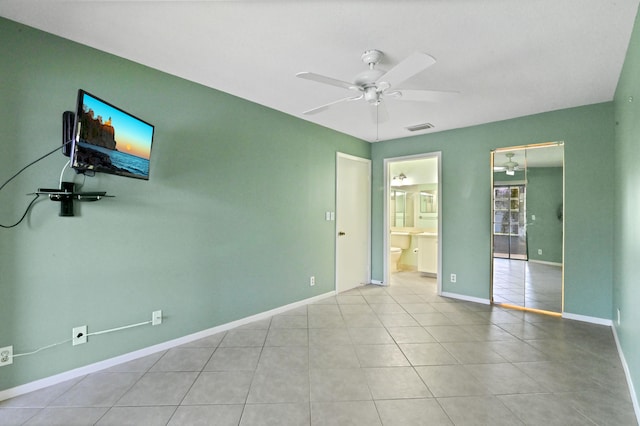 empty room with light tile patterned floors and ceiling fan