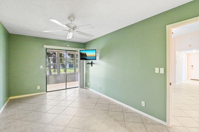 unfurnished room featuring light tile patterned floors and ceiling fan