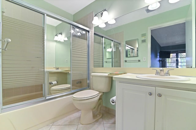 full bathroom featuring enclosed tub / shower combo, vanity, toilet, and tile patterned flooring