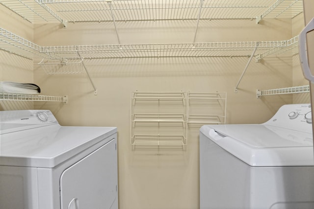 clothes washing area featuring washer and clothes dryer