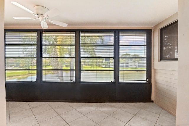 doorway with light tile patterned flooring and ceiling fan