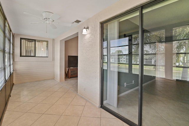 interior space with ceiling fan and light tile patterned floors