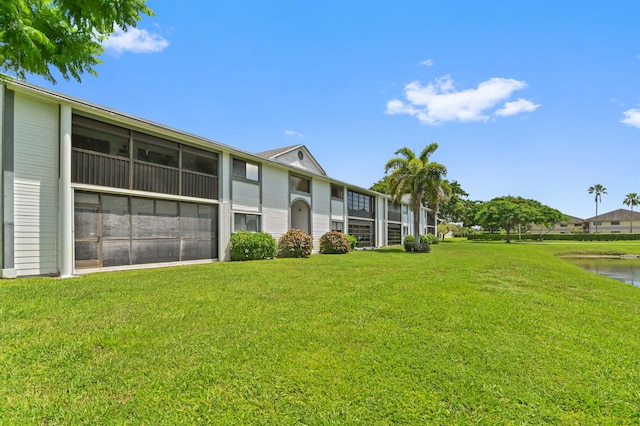 exterior space featuring a water view and a lawn