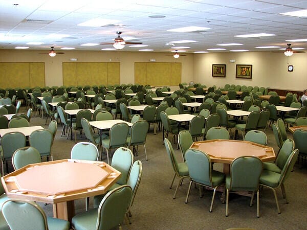 dining space with light colored carpet and a drop ceiling