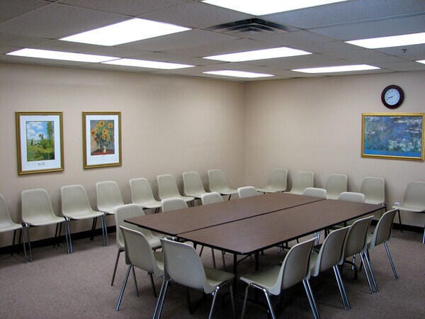 carpeted dining space with a paneled ceiling