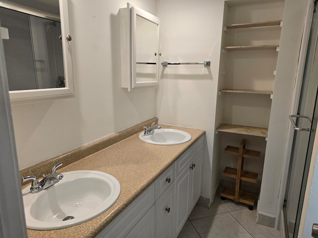 bathroom featuring dual bowl vanity and tile patterned floors