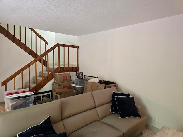 staircase featuring a textured ceiling