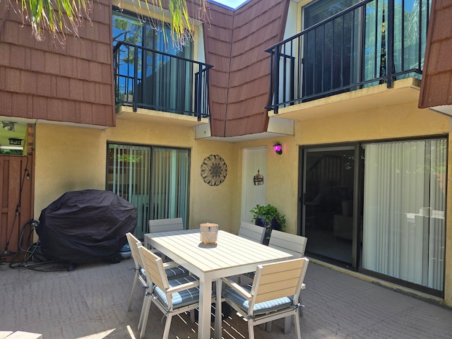 view of patio featuring a balcony and area for grilling