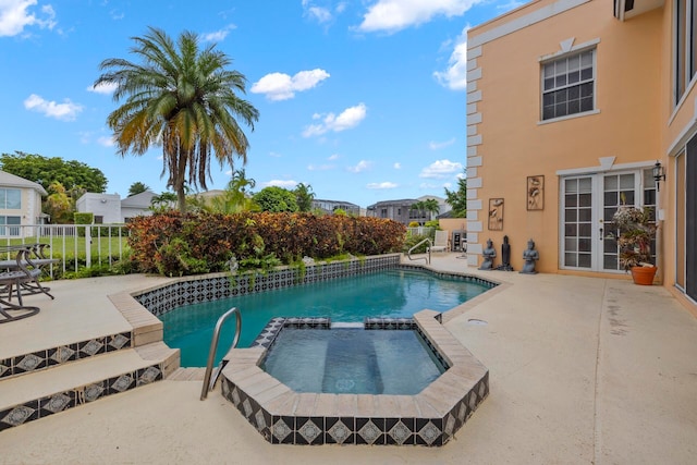 view of swimming pool featuring an in ground hot tub and a patio area