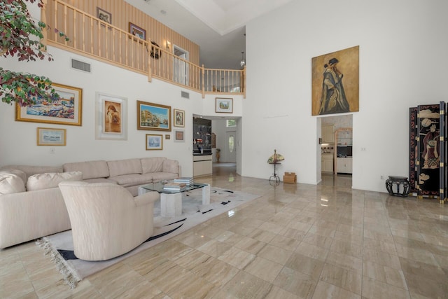 living room featuring a towering ceiling