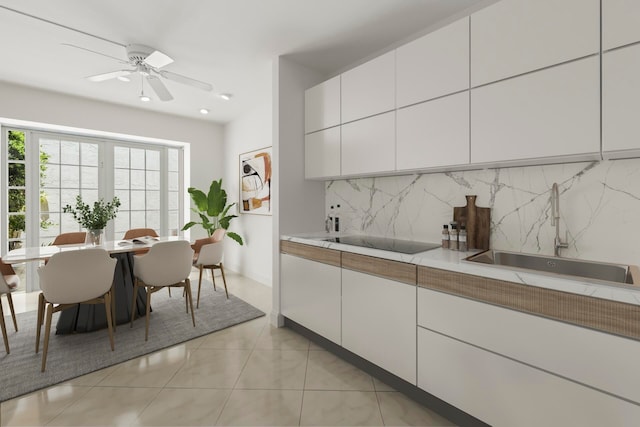 kitchen featuring light tile patterned floors, sink, backsplash, white cabinetry, and black electric stovetop