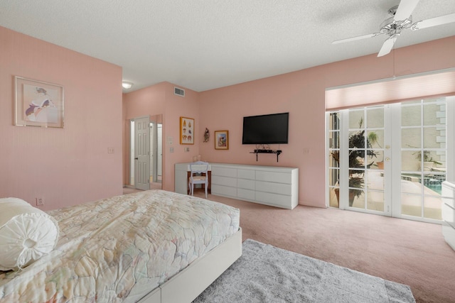 carpeted bedroom featuring access to exterior, a textured ceiling, and ceiling fan