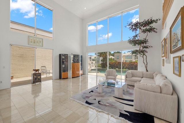 living room featuring plenty of natural light and a towering ceiling