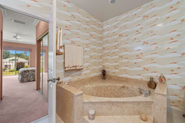 bathroom with a tub to relax in and ceiling fan