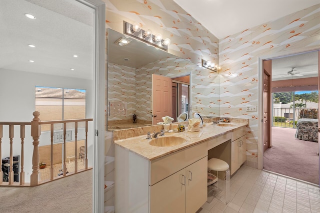 bathroom featuring a textured ceiling, plenty of natural light, vanity, and ceiling fan